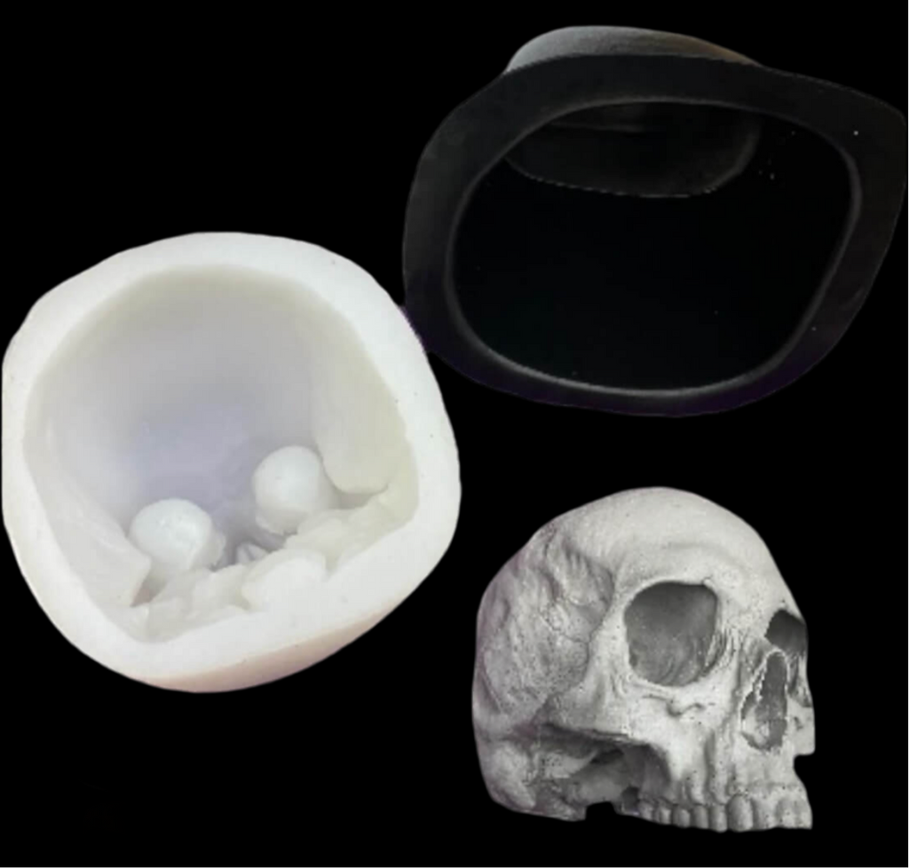 Silicone mold of a skull, black ring, and white skull model on a black background
