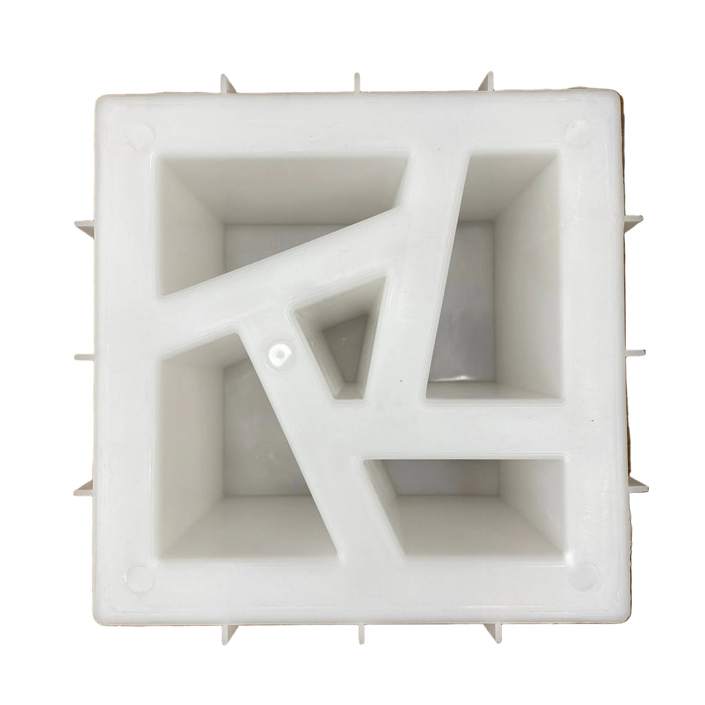Shattered pin breeze block mold by Pacific Mold Design showing cast concrete block with bold fractured expressive broken geometric pattern for artistic statement decorative walls