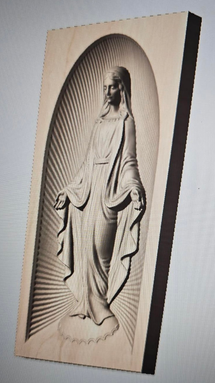 A rectangular wooden plaque featuring a carved relief of the Virgin Mary in an arched frame with sunburst rays, shown against a plain light background.