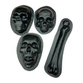 A set of four black ABS plastic molds, including three skull shapes and one femur bone shape, displayed on a white background.