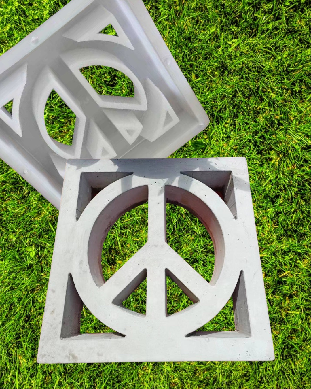 Peace symbol breeze block mold by Pacific Mold Design showing cast white concrete block with iconic peace sign cut-out pattern for decorative mid-century modern garden privacy walls