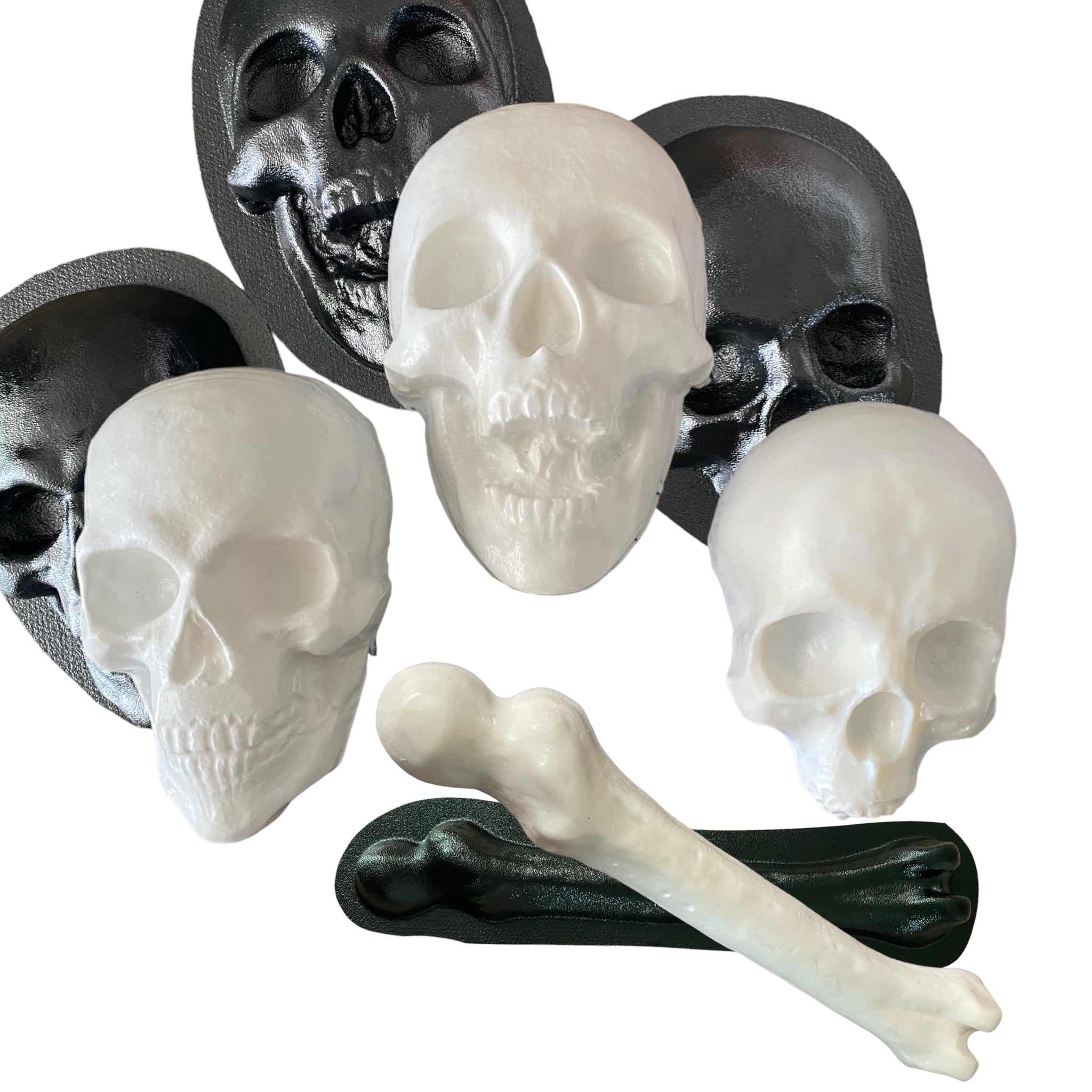ABS skull and femur mold bundle by Pacific Mold Design showing four molds including 8-inch skull, full skull, open jaw skull and femur bone arranged on white surface