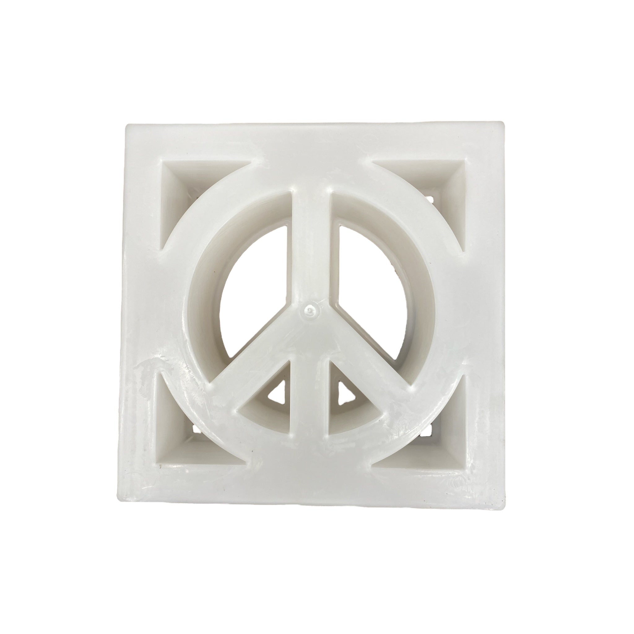 Peace symbol breeze block mold by Pacific Mold Design showing cast white concrete block with iconic peace sign cut-out pattern for decorative mid-century modern garden privacy walls