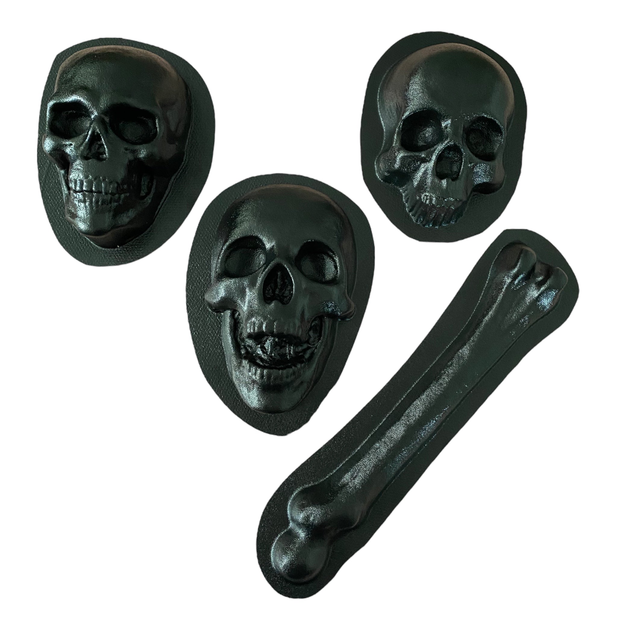 ABS skull and femur mold bundle by Pacific Mold Design showing four molds including 8-inch skull, full skull, open jaw skull and femur bone arranged on white surface