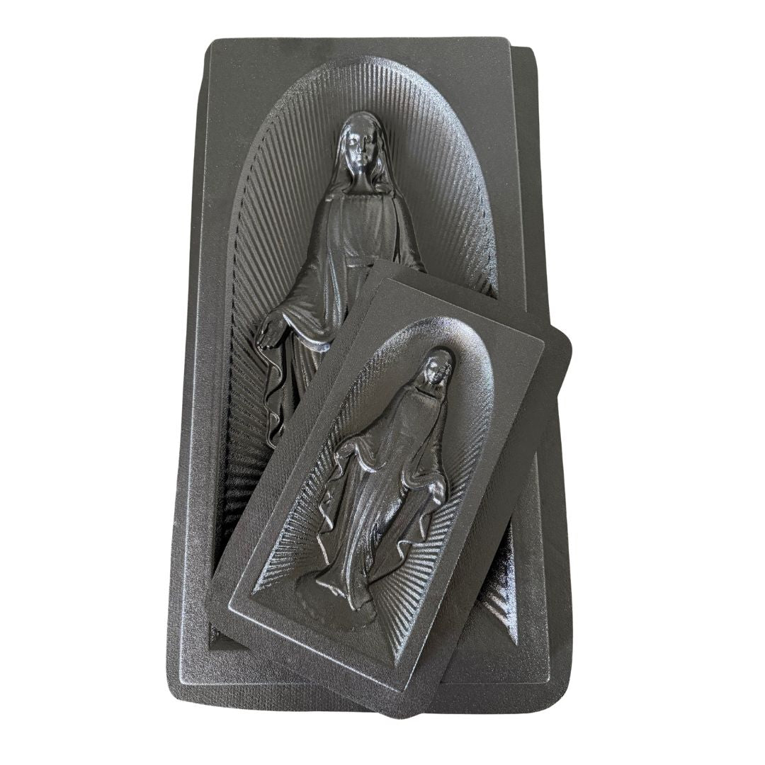 Two dark gray rectangular religious molds with embossed figures in arched recesses, shown on a plain white background.