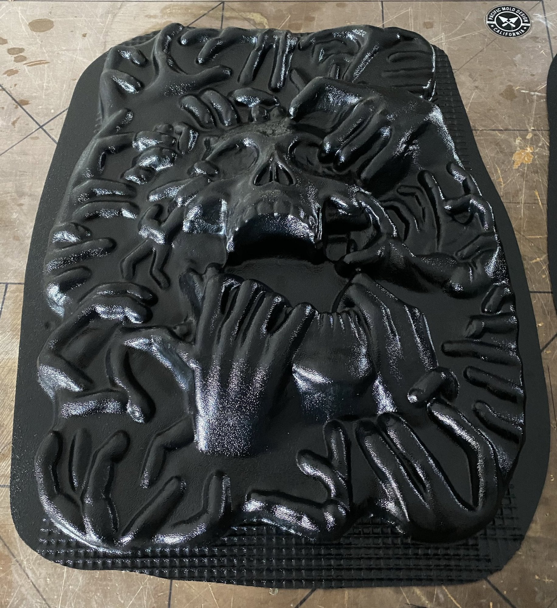 17-inch ripped skull ABS mold by Pacific Mold Design showing large plastic mold of skull being torn apart by hands on each side designed for concrete or plaster casting