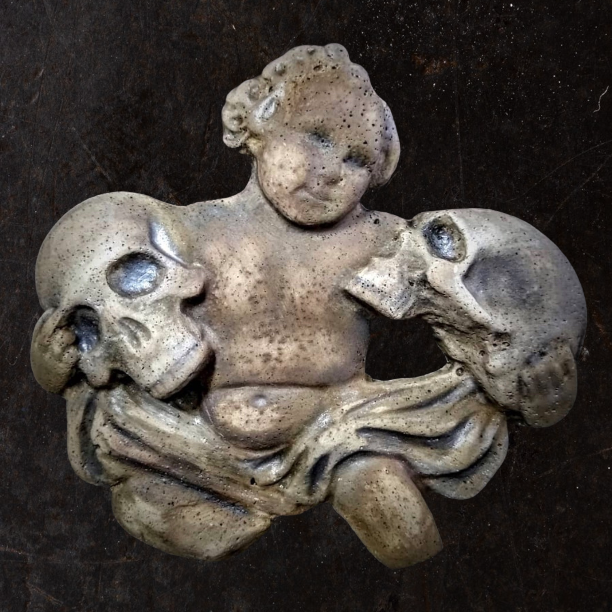12-inch cherub holding skulls ABS casting mold by Pacific Mold Design showing gothic angel cherub figure holding two human skulls for casting concrete and plaster gothic wall art and cemetery décor