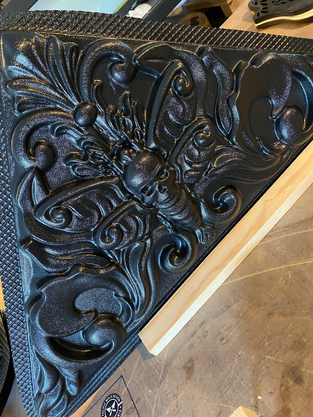 Death moth ABS mold by Pacific Mold Design showing large 28-inch black plastic mold of detailed moth with skull imagery and spread wings designed for concrete or plaster casting