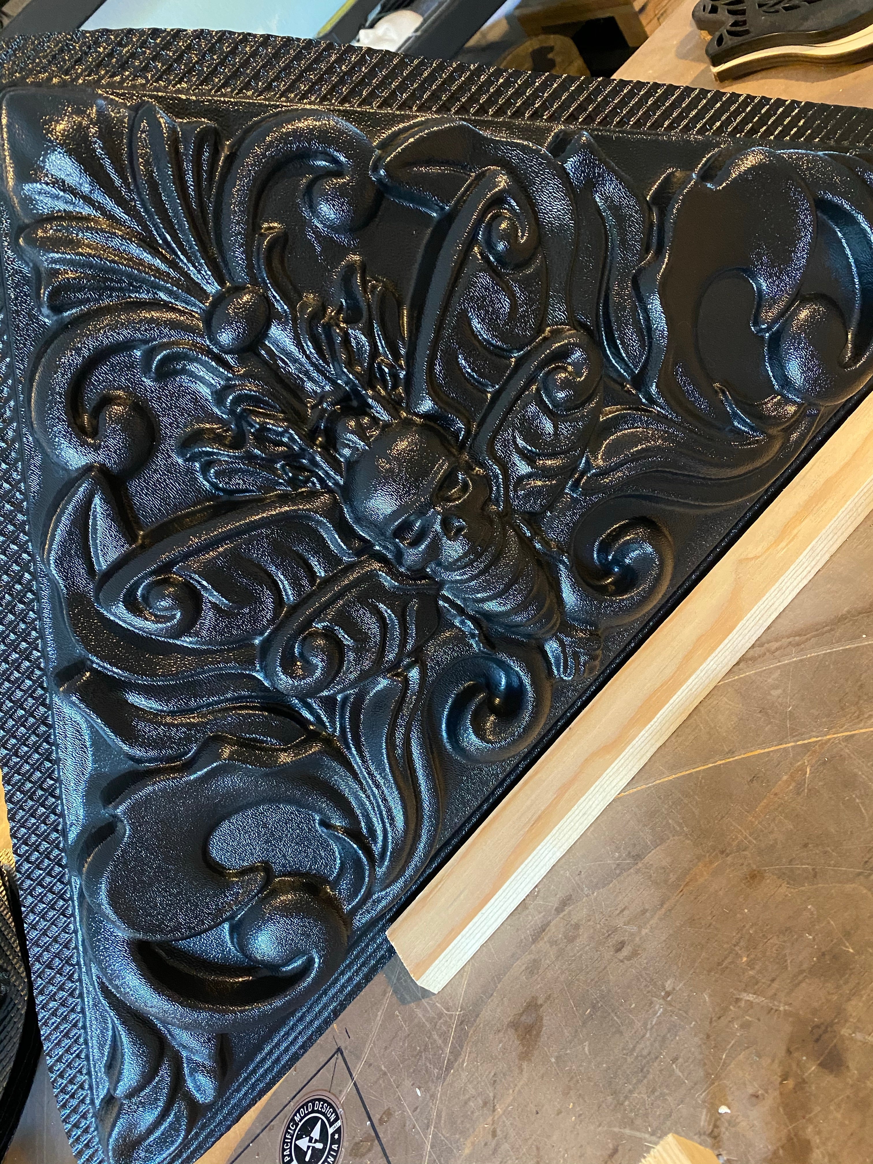 Death moth ABS mold by Pacific Mold Design showing large 28-inch black plastic mold of detailed moth with skull imagery and spread wings designed for concrete or plaster casting