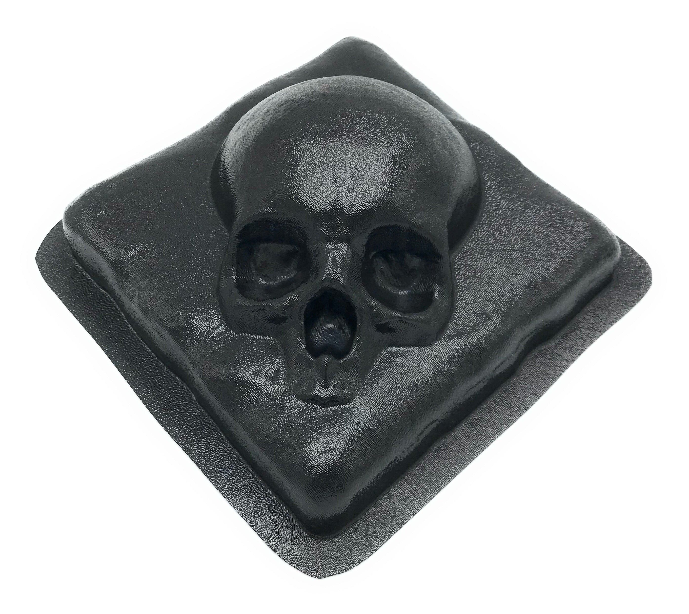 Skull on a rock ABS casting mold by Pacific Mold Design showing 8-inch square mold with skull embedded in stone texture for use as backsplash tile or fireplace accent