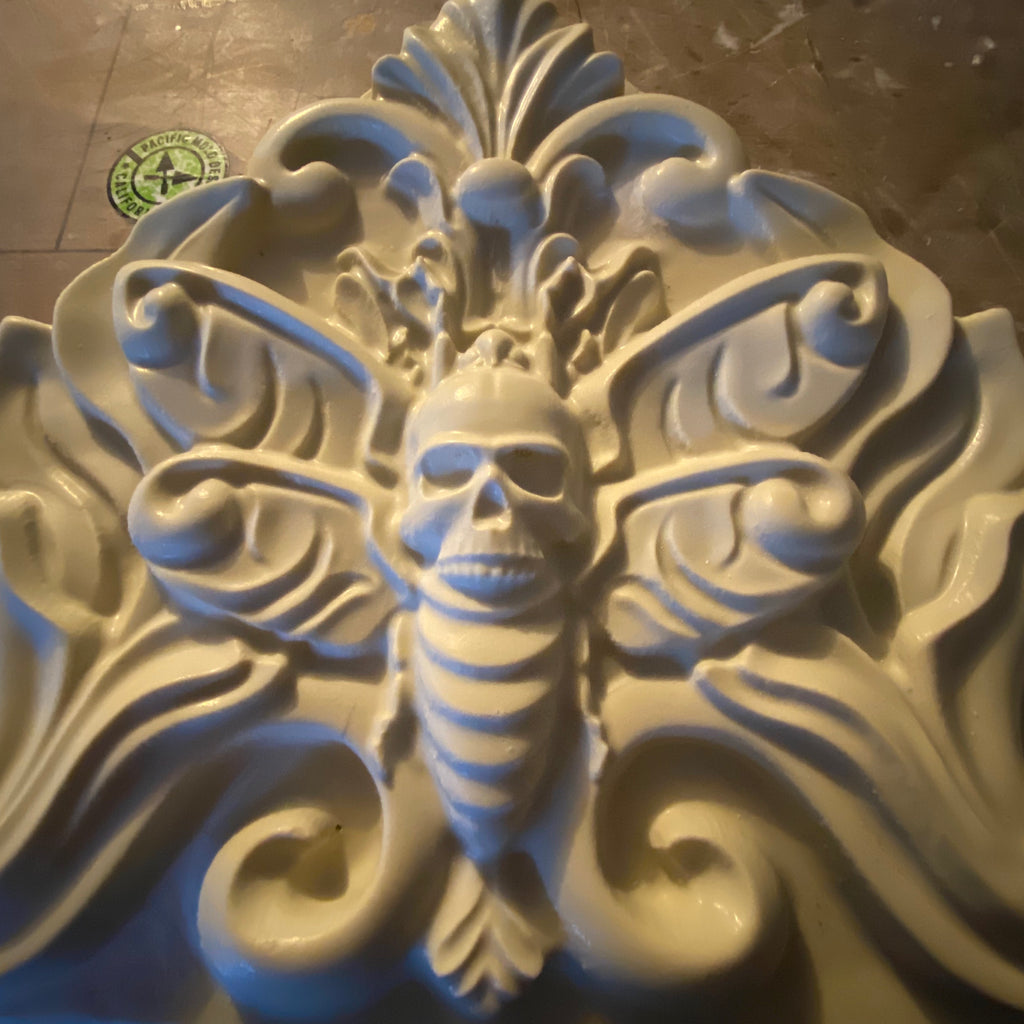 Death moth ABS mold by Pacific Mold Design showing large 28-inch black plastic mold of detailed moth with skull imagery and spread wings designed for concrete or plaster casting