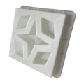 A white concrete breeze block with a geometric pattern.