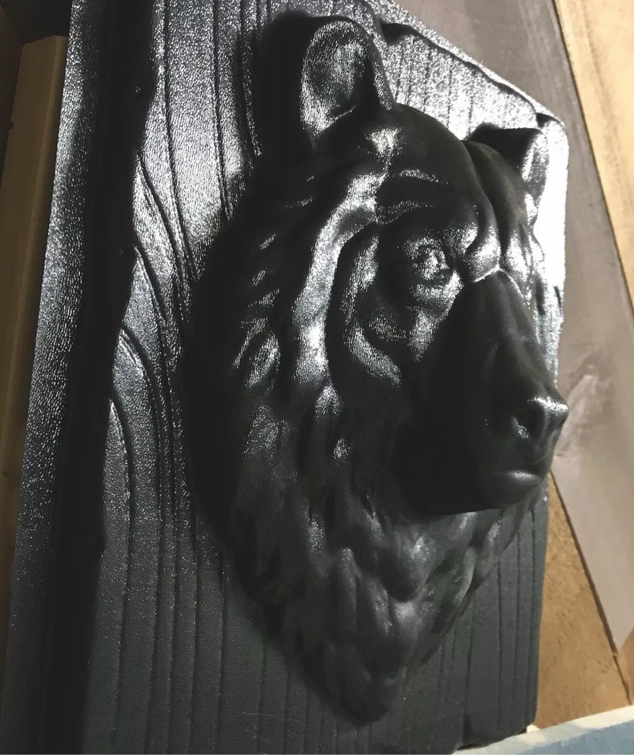 14-inch bear head ABS casting mold by Pacific Mold Design showing realistic bear face with 4-inch snout depth mounted on wood grain plank texture for concrete and plaster cabin and garden wall art