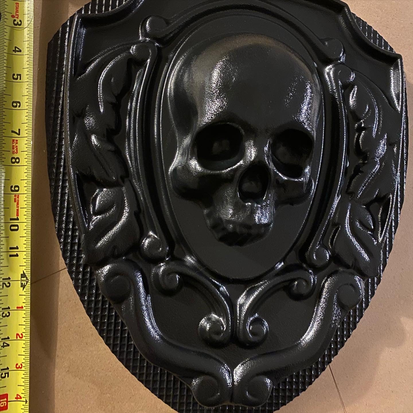 16-inch skull crest ABS mold by Pacific Mold Design showing gothic shield-style mold with skull centerpiece design measuring 16 by 14 inches for concrete and plaster casting