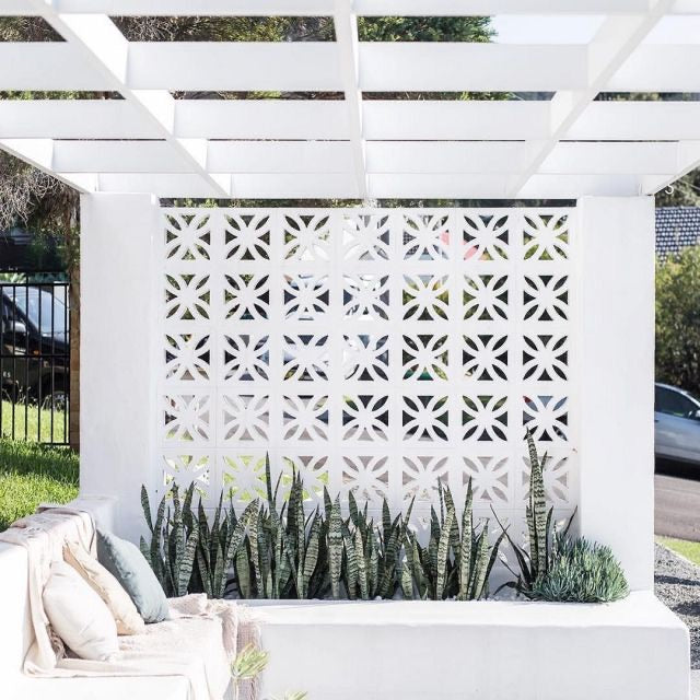 Sunflower breeze block mold by Pacific Mold Design showing cast white concrete block with vintage 1930s sunflower floral geometric pattern for retro decorative garden walls and patio privacy screens